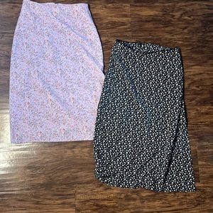 Two John Galt patterned slip skits with side slit and back zipper.